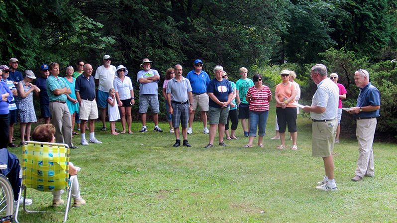 Rick Bodenschatz, second from right, talks about Lutherland with the group gathered for the marker dedication.