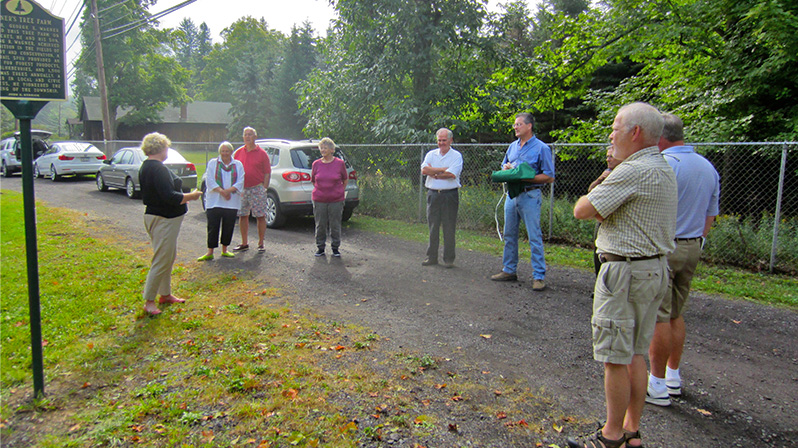 Trudi Denlinger, left, addresses those gathered for the dedication of the Wagner’s Tree Farm historical marker.